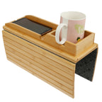 Bamboo armrest tray with a phone slot and cup holder, mug and phone in place, on white