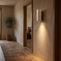 Travertine marble wall lamp lighting a hallway