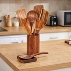Wooden cooking utensil set in its holder on a kitchen counter
