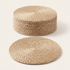 Round braided straw placemats, one flat and the rest stacked